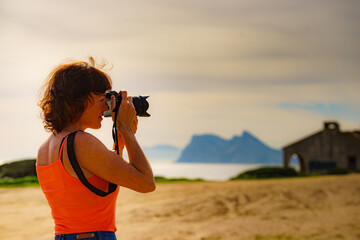 Tourist with camera on spanish coast.