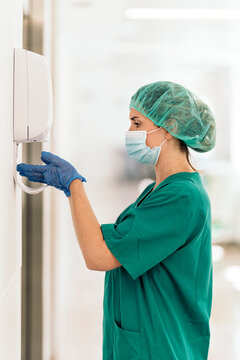 Female Doctor Applying Hand Sanitizer