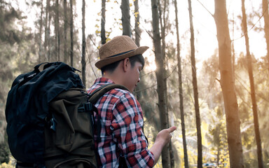 Asian man traveling and camping in forest with happiness