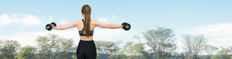 Fototapeta na wymiar Young attractive woman doing exercise working outdoors.