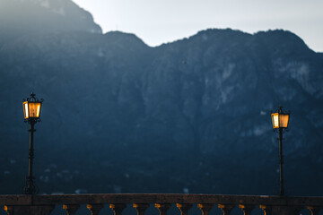 Two vintage lamps on the coast by the lake at sunset