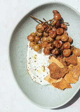 Roasted grapes with yogurt, cumin and pita crackers
