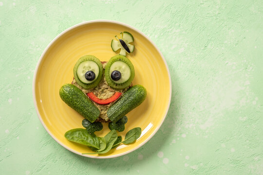 Funny frog toast with cucumber and mashed avocado