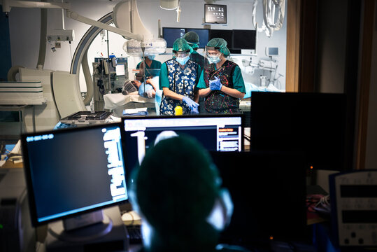 Back View of Faceless Doctor Using Computer