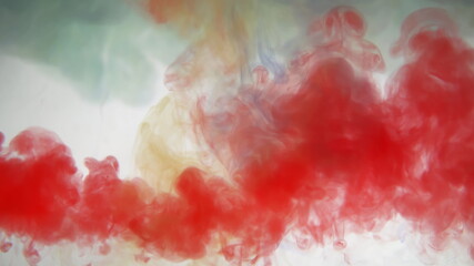 Mixing yellow and blue and red paint colors in water. Colored smoke effect