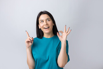 Smiling girl gesturing OK sign with her hand