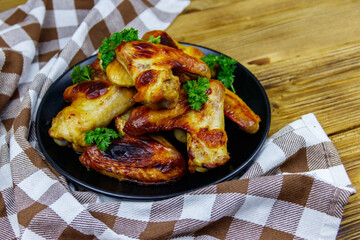 Baked chicken wings on a wooden table