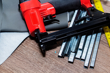 concept of furniture production and repair. Stapler and staples, working tool