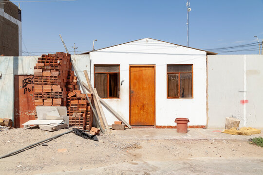 A humble little house of the local Paracas inhabitants, unpainted and with some lack of maintenance, in the Chaco area, on a sunny and scorching day.