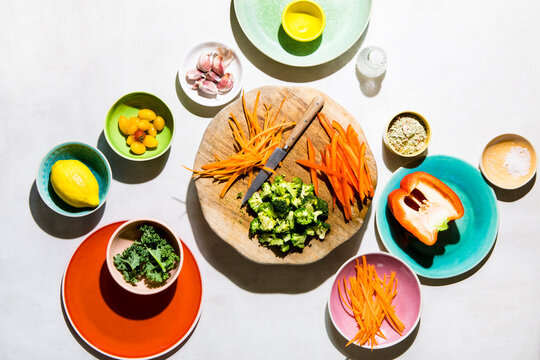 Chopped Vegetables and fresh ingredients in brightly coloured bowls, hard light