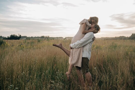 Young couple hugging in field