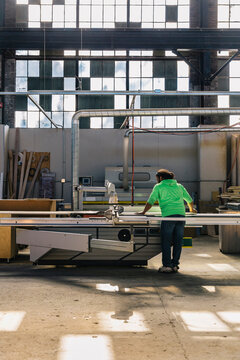 Hispanic Man at work Cutting Cabinet