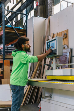 Hispanic Man at work operating Machinery