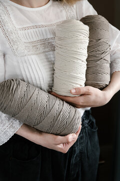 Woman holding spools with threads