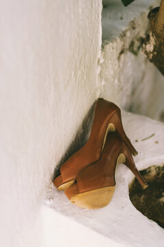 brown pumps laying on the street outdoors