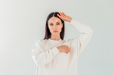 Mock-Up. portrait of a beautiful girl with black long hair in a hoody on a white background. the concept of sport