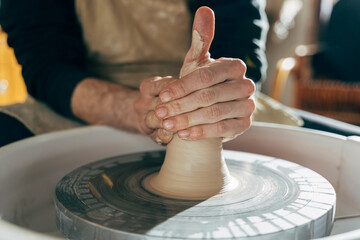 Potter's hands shaping a bowl on the spinning by clay, mold, crockery, earthenware