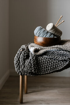 Knitting tools and textile on chair