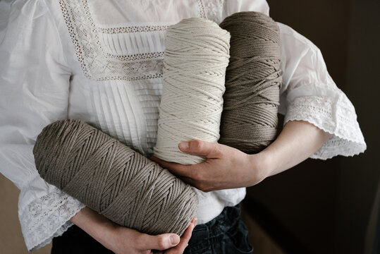 Woman holding spools with threads
