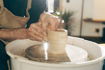 Close up view of the male sculpt new utensil with a tools and water