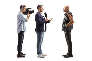 TV reporter and a cameraman interviewing a bald punk rocker