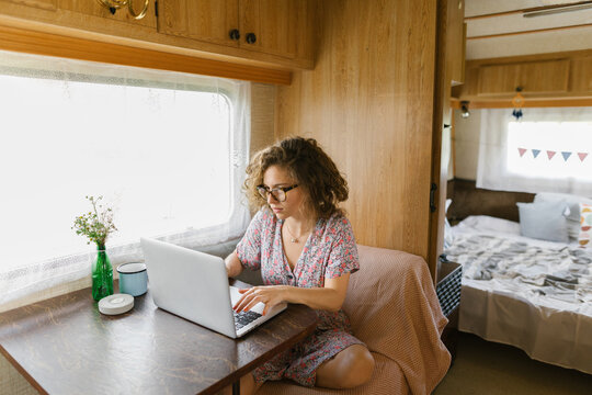 Girl working on her laptop in a trailer