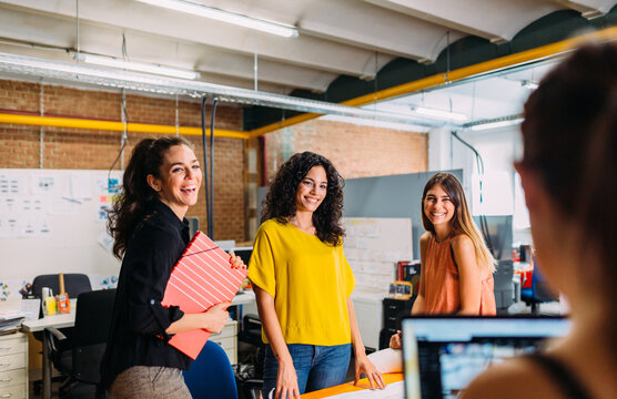 Businesswomen talking to each other at a creative office