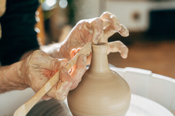 Concentrated master at the potter's wheel closeup