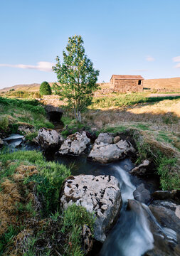 River and barn at sunset. Aisgill, Cumbria Yorshire border, UK.