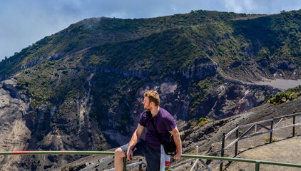 Fototapeta na wymiar Man seating and looking out to the mountains 