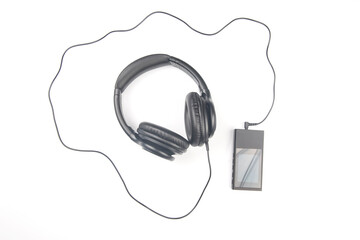 Headphones for listening to music with digital audio player on white background