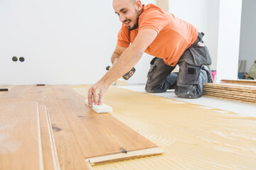 craftsmanr  laying parquet flooring in a modern house