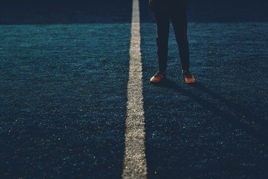 football player on a soccer field with artificial turf - Powered by Adobe