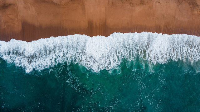 Aerial shot of the ocean shore and waves