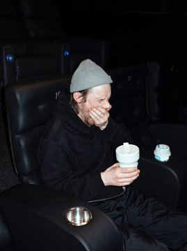 Young man bored at cinema