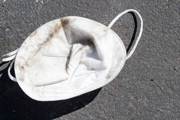 Discarded covid mask in a parking lot