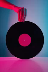 Foto op Canvas Hand hold retro vinyl disc with neon lights. Vintage music background © Lazy_Bear