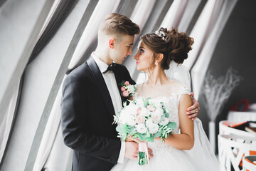 Perfect couple bride, groom posing and kissing in their wedding day