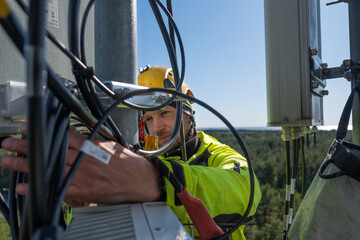 Cell phone installers work on the tower