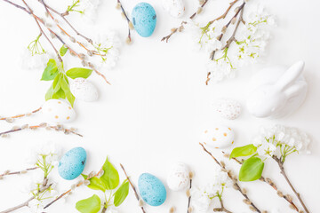 Flat lay easter composition with spring flowers and eggs on white background