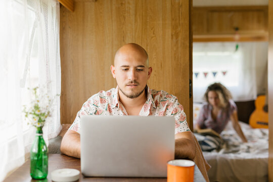 Man working on his laptop in a trailer