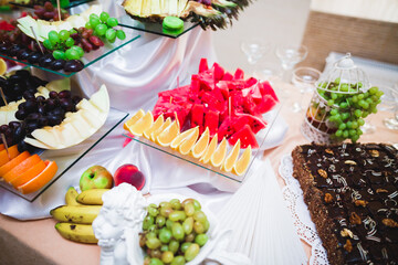 Delicious and tasty dessert table with cupcakes and shots at reception closeup