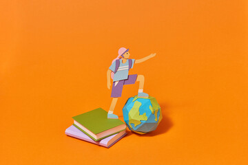 Handmade paper schoolboy is ready for studying.