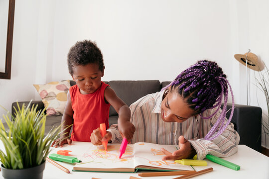 Mother and son drawing at home
