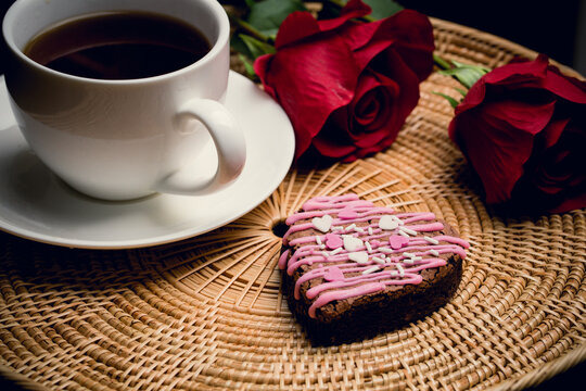 Coffee break with romastic heart shpe of cookie and red rose represent love on valentine day
