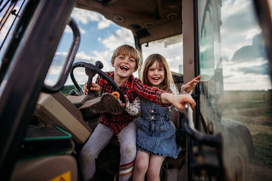 two kids in a tractor