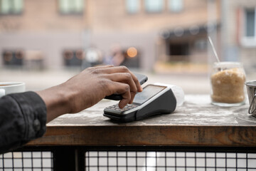 Crop View Of Anonymous Black Hand Using Cellphone For Paying