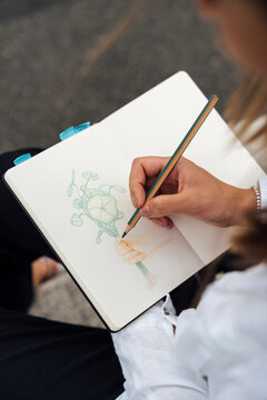 Woman Colouring and Drawing with Pencils