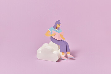 Papercraft schoolgirl is reading book on a clouds.