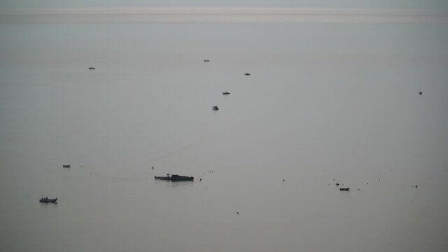 Fisher boats on the atlantic ocean, one fisherman boating